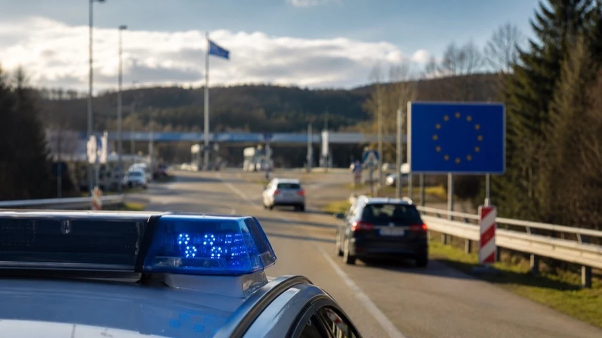 Europäische Grenzstraße mit Polizeifahrzeugen im Hintergrund als Symbol für internationale Fahndung nach vermissten Kindern